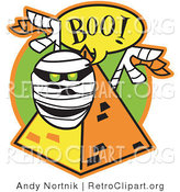 Retro Clipart of a White Mummy with Green Glowing Eyes Peeking out from Behind a Pyramid and Screaming "Boo!" by Andy Nortnik